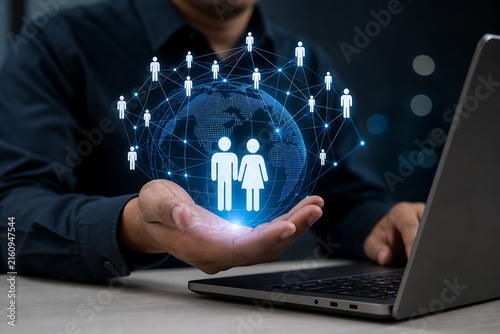 Hands holding digital network of people icons over laptop in dark office