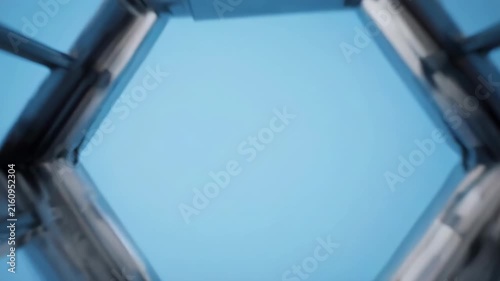 Futuristic Hexagonal Tunnel with Cinematic Upward Motion and Blue Sky Backdrop