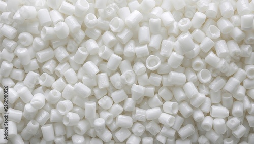 Obraz na płótnie White Plastic Pellets Spread Out on a Surface in Closeup View