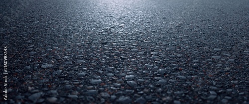 Closeup of Textured Asphalt Surface with Reflective Wet Finish