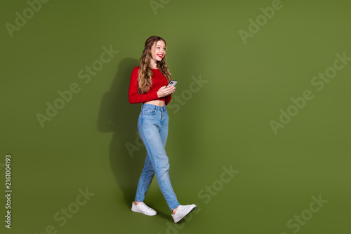 Принти на полотні Young fashionable model walking smiling with phone wearing red top and jeans aga