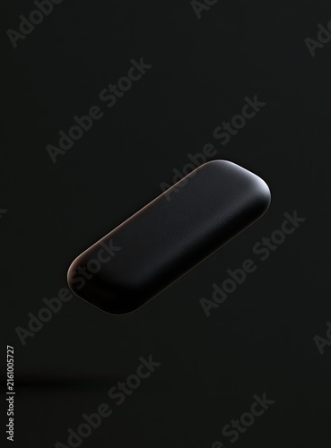 Plakat A single, smooth, dark, oblong shape hovers against a deep, shadow-filled background