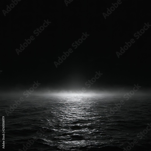 Dark, foggy expanse of water illuminated by a single, bright light source