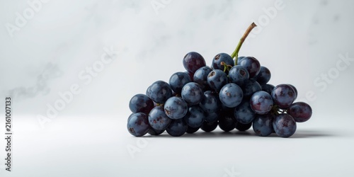 Fresh Dark Purple Grapes Cluster on a Minimalist Background