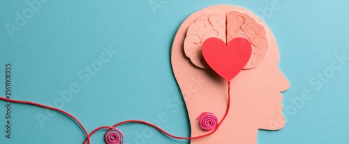 Papercraft profile with brain, heart, and connected red string