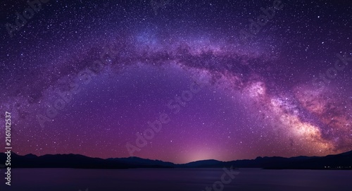 Plakat w ramie Milky Way Galaxy Arching Over Dark Mountain Silhouette at Twilight