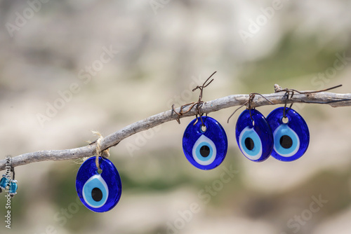 Konstfotografi Traditional blue nazar evil eye charms hanging from a branch in Turkey