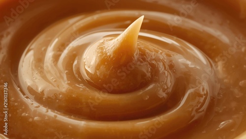 Creamy Caramel Sauce Swirled in a Bowl with Glossy Texture