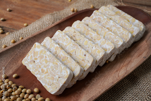 Obraz na płótnie Raw tempeh on the wooden plate