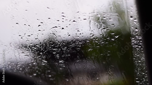 Car windshield with rain drops and frameless wiper blade,Traffic Jam with raining in evening day in the city,Drops of water on the car after rainy,outside car,Raindrops falling on a glass