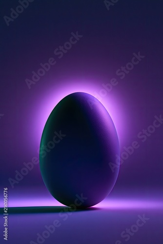 Mysterious dark egg glows with purple light on a reflective surface