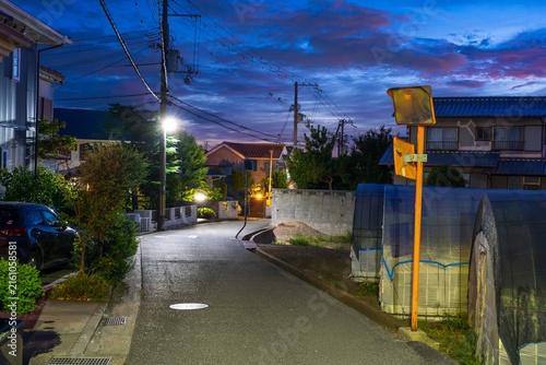 Fotografie Empty road in quiet suburban neighborhood at dawn