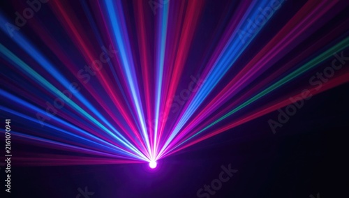 Colorful Laser Light Rays Spreading from a Central Point in Dark Background