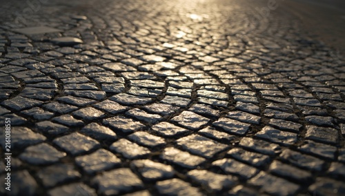 Obraz na płótnie Cobblestone Pavement Surface Glimmering Under Sunset Light