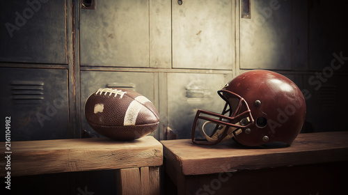 A vintage-style American football helmet sits alongside a scuffed leather football on a wooden bench inside a classic, rustic locker room setting, capturing the true heritage and tradition
