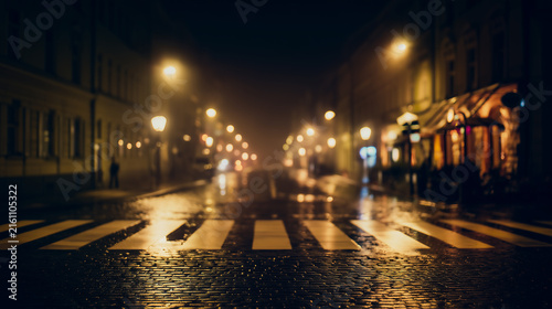 Empty city street with pedestrian crossing at night in rain, reflecting golden bokeh street lights on wet asphalt, creating a moody, cinematic, and calm urban atmosphere.