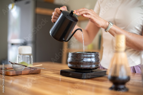 Photography Woman Pouring Hot Water into Matcha Bowl with Gooseneck Kettle During Traditiona