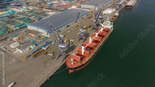 Bild auf Leinwand Aerial View of Port Terminal with Cargo Ship and Cranes