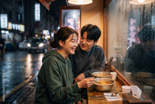 Cozy couple sharing ramen at a street food stall on a rainy night for restaurant social media background and cozy lifestyle banner
