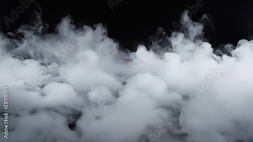 Thick white smoke or fog on dark background with dense mist and vapor clouds