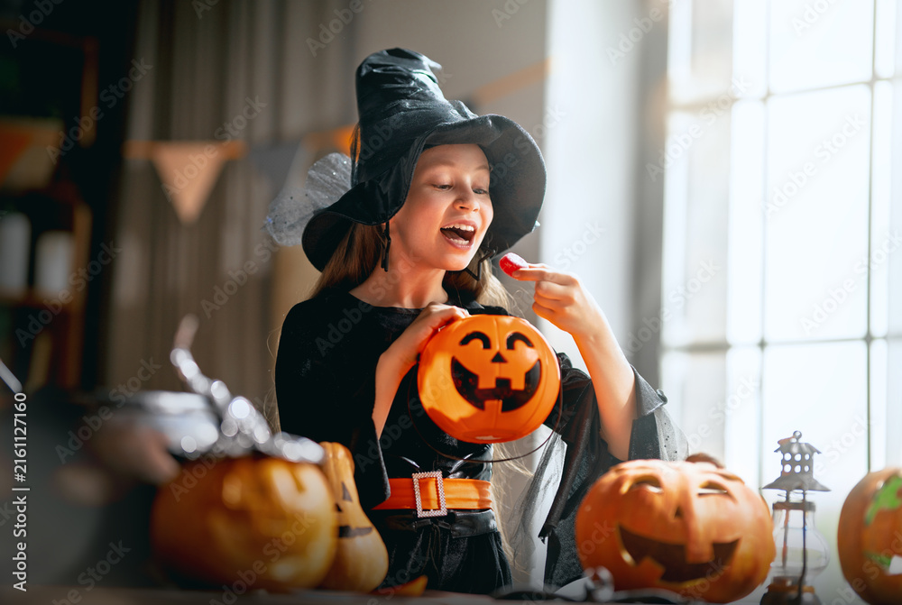 Naklejka premium Joyful Child Dressed as Witch Celebrating Halloween