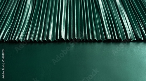 Dark green corrugated metal surface texture background pattern.