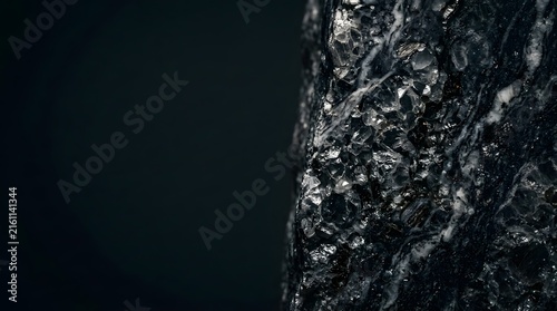 Natural dark stone texture showing rough volcanic rock surfaces with deep crystalline structures providing a rugged earth material finish for architectural projects that require heavy organic