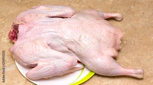 hostess is preparing a large fat duck for  festive table