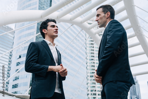 Two Hispanic Latin Businessmen Talking Serious Discussion Corporate Meeting Modern City Outdoor