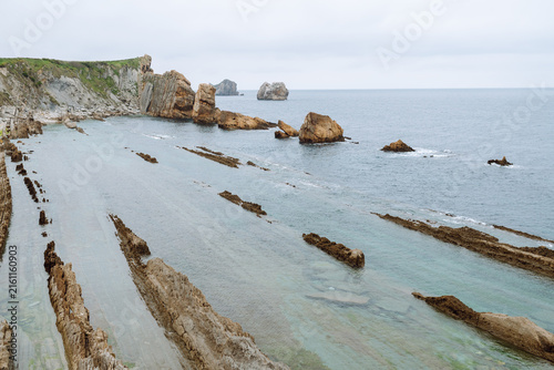 Fotografie A stunning seascape with large cliffs jutting out of the water
