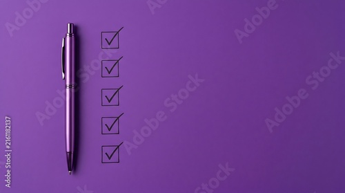 Purple checklist with pen on purple background demonstrating successful completion of tasks and goal achievement for planning and organization projects.