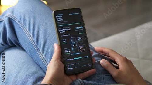 Driver reviews a fictional electric vehicle health dashboard showing battery, engine, tire pressure and brake wear, highlighting predictive maintenance and connected car technology.