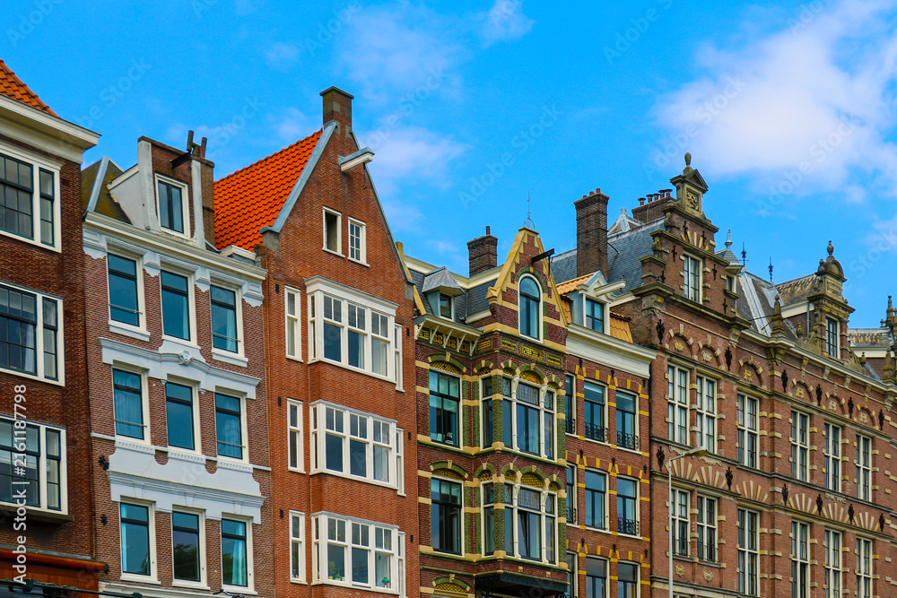 Obraz premium Old traditional brick wall houses row in city of Amsterdam