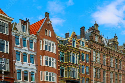 Old traditional brick wall houses row in city of Amsterdam