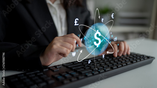 Canvastavla Businessperson Using Keyboard with Currency Symbols and Digital Globe Representing Global Finance Concept in Modern Office Environment
