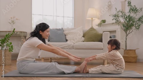 Woman and Child Stretching Together on Exercise Mat in Bright Living Room, Family Bonding Through Wellness, Fitness, Yoga, and Healthy Home Exercise Session
