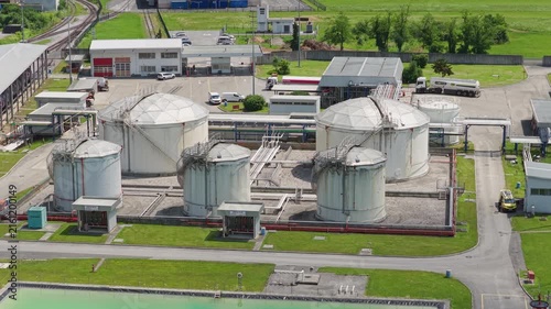 This aerial view shows a large oil storage facility with multiple tanks.