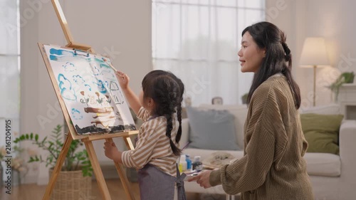 Mother and Child Painting on Easel at Home, Sharing Family Creativity Through Art, Learning Colorful Lesson Together Near Bright Window in Warm Living Room