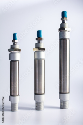 Front view of three stainless steel round mini pneumatic air cylinders standing vertically in a row on a white background for industrial automation components.
