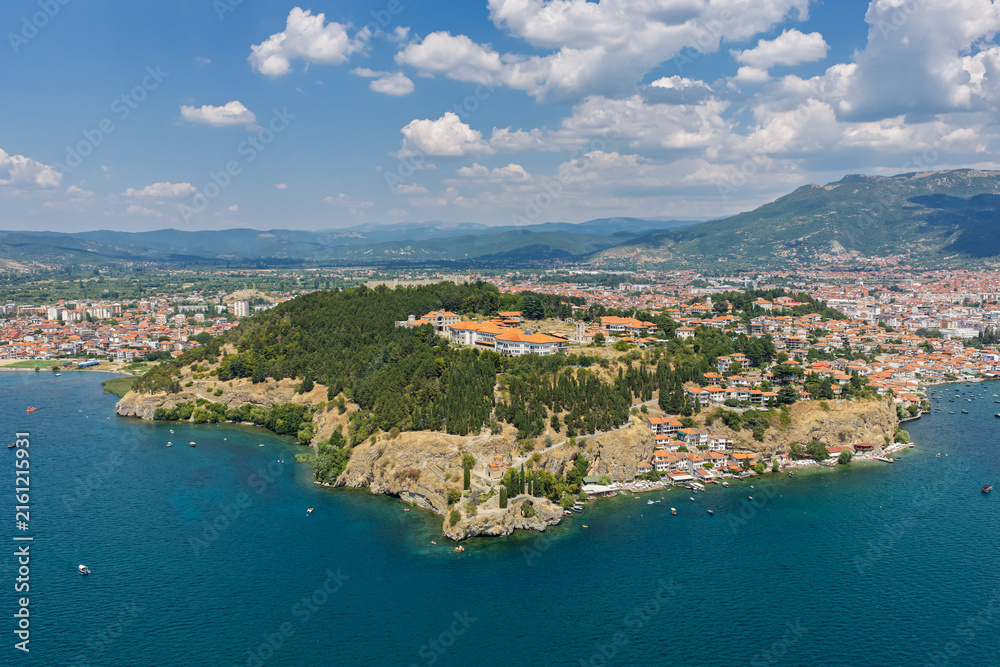 Fototapeta premium Aerial drone view of Ohrid in North Macedonia during summer, featuring historic old town, UNESCO heritage landmarks, harbor and crystal clear Lake Ohrid surrounded by scenic landscape