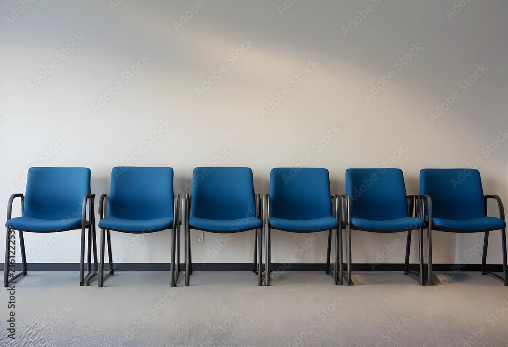 Obraz premium Job market and unemployment crisis, empty blue chairs in a waiting room layoffs and corporate downsizing