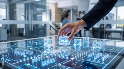 A hand manipulating transparent digital blocks on a futuristic touchscreen interface, showcasing advanced technology.