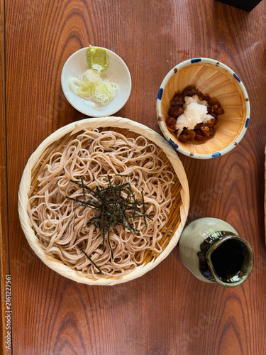 Traditional Japanese soba noodles served on a bamboo tray with nori, accompanied by mushrooms, grated daikon, wasabi and scallions, photographed at a restaurant near Jindaiji Temple in Chofu, Tokyo