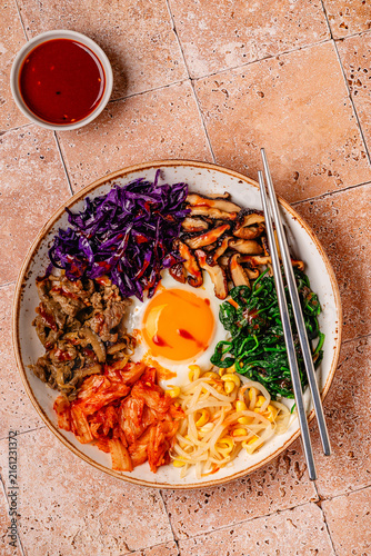 Bibimbap with colorful vegetables, beef, and egg