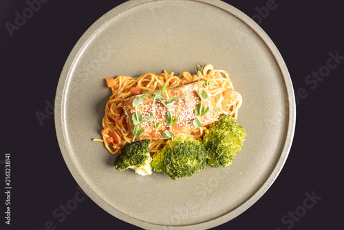 Canvastavla Pan seared salmon steak with spaghetti, steamed broccoli, and sesame seeds top v
