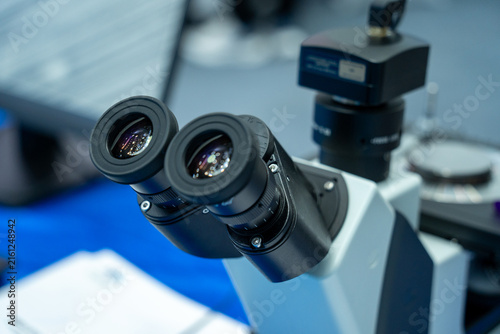 Bild auf Leinwand Binocular Head of Laboratory Optical Microscope with Camera Attachment