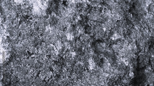 Картината върху платно Extreme close-up black and white texture of a rough weathered rock surface, showing porous details, mineral patterns and natural erosion for an organic background