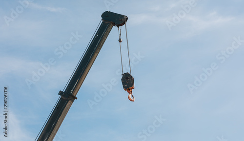 Military Vehicle Crane Boom with Lifting Hook Against Blue Sky
