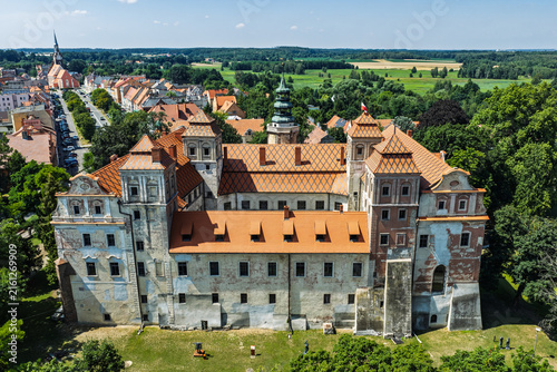 Aerial view of the Ducal Castle in Niemodlin, Poland with market square, old town, colorful buildings and streets in the historic city center on a sunny day. Castle and square in Niemodlin, Poland