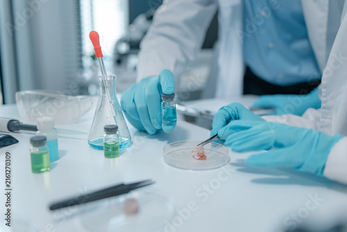 Biomedical scientists perform laboratory experiments using microscopes, laboratory glassware, and biological samples while recording results to support medical research, diagnostics and biotechnology.